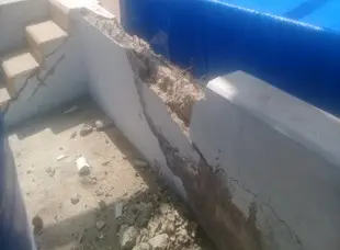 Muro de concreto agrietado y desprendido antes de la intervención